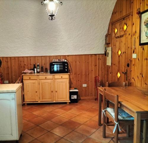 a kitchen with a table and a tv on a counter at Il Nido di Concesio in Concesio