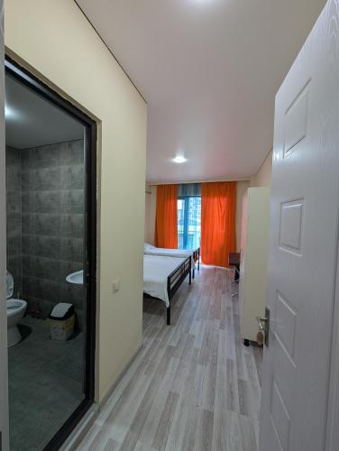 a room with a bedroom with a bed and a bathroom at Compass hotel in Kobuleti
