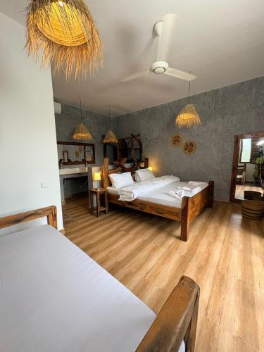 a large bedroom with two beds and a table at NoyaAfrika Kendwa Boutique in Kendwa