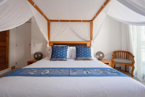 a bedroom with a large bed with a canopy at Lagoa Beach House B&B - Breakfast included in Serra do Bouro
