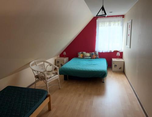 a bedroom with a bed and a chair in a attic at Gorczyca Reset in Płaska