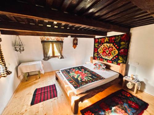 a bedroom with a bed in a room with a rug at Hafia Legacy in Berbeşti