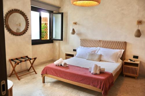 a bedroom with a bed with two towels on it at Taga Suites in Catania