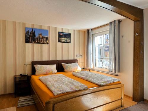 a bedroom with a large bed with a window at Fewo Helene im Haus Moselwelt in Zell an der Mosel