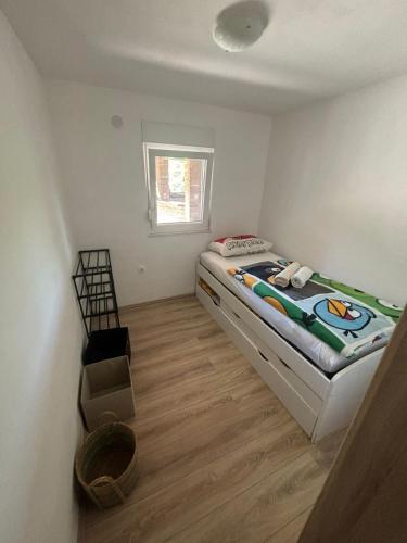 a small bedroom with a bed in a room at Jelica in Polje