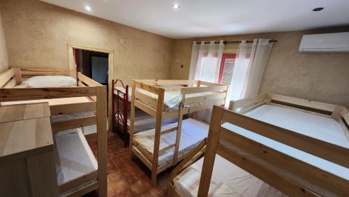 a room with three bunk beds in it at El Bosque de la Herrezuela in Guisando