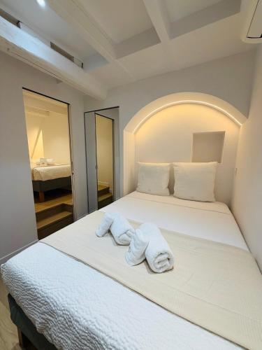 a bedroom with a bed with towels on it at Monaco - Menton Old Town - Climatisation - Seaview - Luxury rénovation in Menton