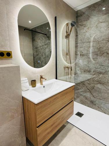 a bathroom with a sink and a mirror at Monaco - Menton Old Town - Climatisation - Seaview - Luxury rénovation in Menton