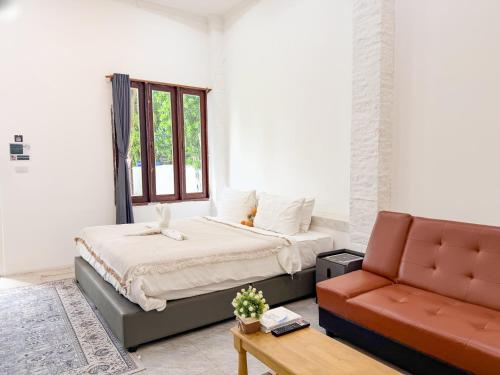 a bedroom with a bed and a couch at Three CoCo Villa AoNang Beach in Ao Nang 