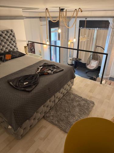 a bedroom with a large bed with a black blanket at Apartment Zumbul in Zrenjanin