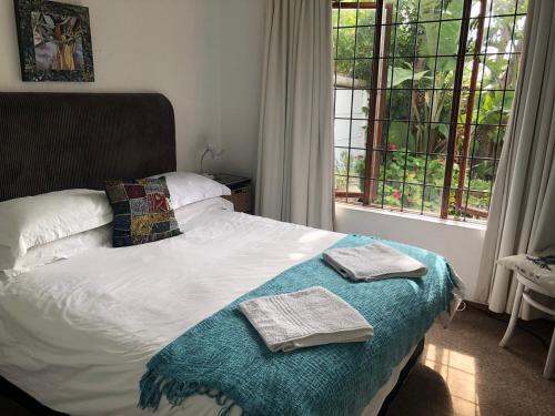 a bedroom with a bed with two towels on it at The Owls Nest in Lakeside