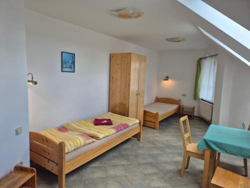 a bedroom with a bed and a table and chairs at Pension Camp Prager in Prague