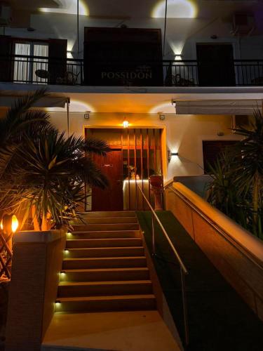 a set of stairs leading to a building at night at Possidon in Agia Marina Aegina