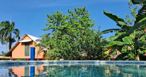 a house and a swimming pool in front of a house at Labellaventura in Las Galeras