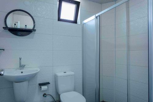 a bathroom with a toilet and a sink and a shower at Best Alanya Hotel in Alanya