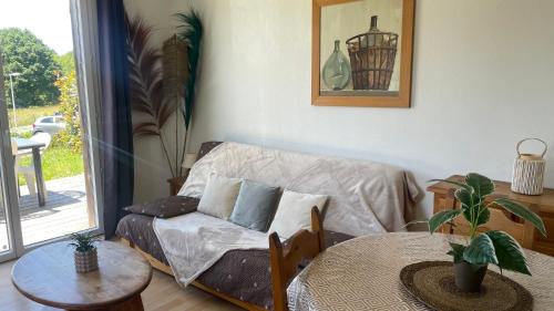 a living room with a couch and a table at Gîte du bosquet in Égletons