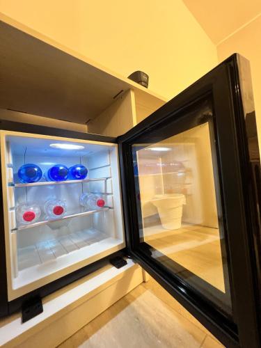 a refrigerator with its door open in a room at Foresteria Lombarda Pavia in Pavia
