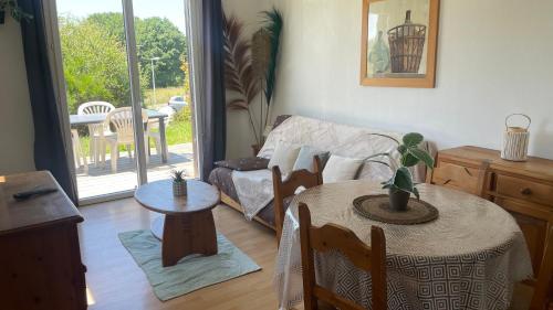 a living room with a table and a couch at Gîte du bosquet in Égletons