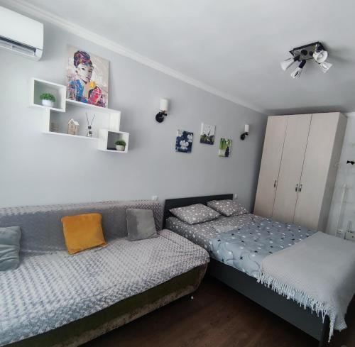 two beds in a room with white walls at Сдается квартира у Озера in Balqash
