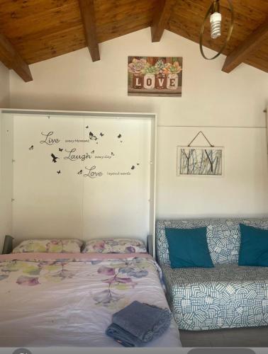 a bedroom with two beds and a writing on the wall at Sweet NiMa in Francavilla al Mare
