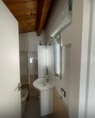 a bathroom with a sink and a toilet at Sweet NiMa in Francavilla al Mare