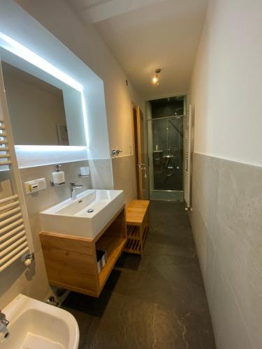 a bathroom with a sink and a toilet and a mirror at Villa Alessandra in Colle Isarco