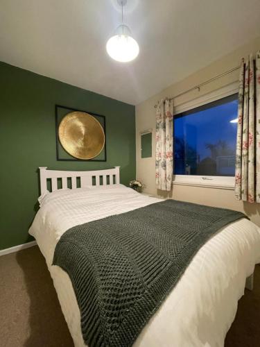 a bedroom with a large bed with a large window at Beach Chalet Home in Scratby