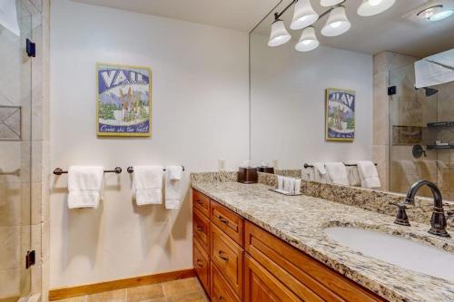 a bathroom with a large sink and a shower at Lion Square Lodge East 310 in Vail