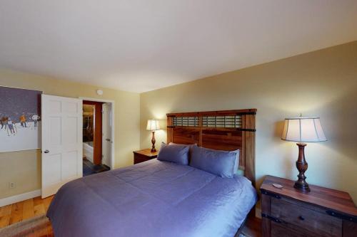 a bedroom with a large bed with a wooden headboard at Quaint Mountain Condo in Frisco
