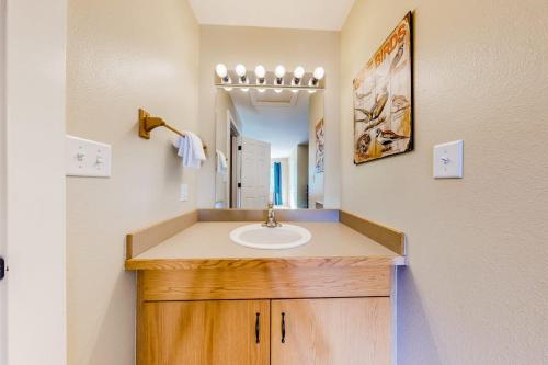 a bathroom with a sink and a mirror at Firelight Chalet 94 in Big Sky