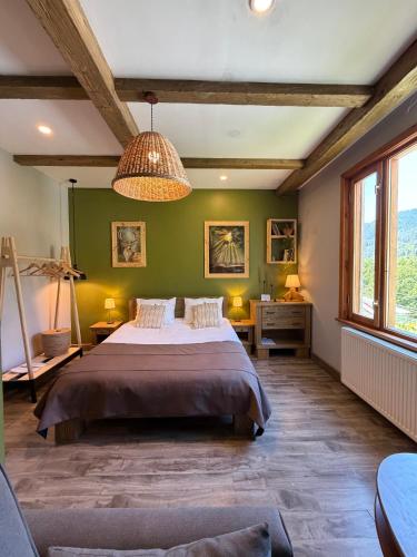 a bedroom with a large bed and green walls at Hotel Borjomi Verde in Borjomi
