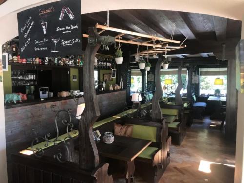 a restaurant with a bar with a table and chairs at hotel spiegeltaler eck in Wildemann