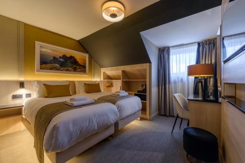 a hotel room with two beds and a window at The Gable, Dingle in Dingle