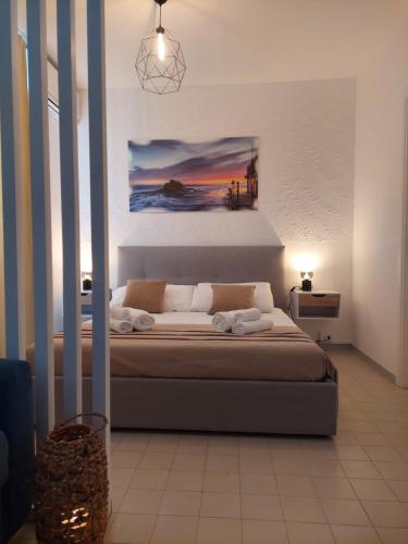 a bedroom with a bed with a painting on the wall at Monolocale 100metri dal mare in Fano