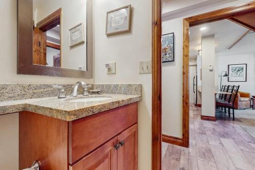 a bathroom with a sink and a mirror at Lion Square Lodge South 556 in Vail