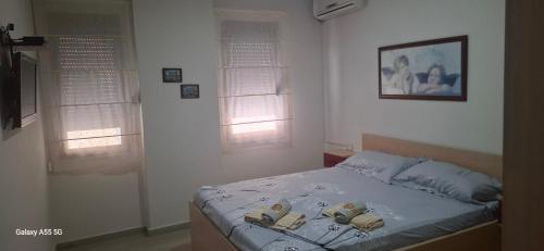 a bedroom with a bed with shoes on it at Pine Apartment 2 plus 1 in Golem
