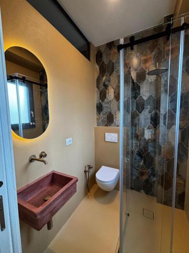 a bathroom with a wooden sink and a toilet at Riad Gilda in Torre Canne