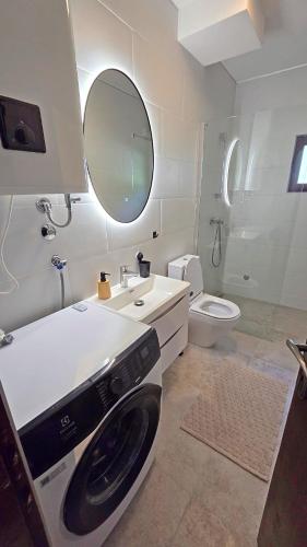 a bathroom with a washing machine in a sink at Villa Sava in Đenovići