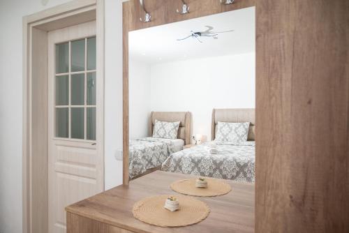 a bedroom with two beds and a table with two hats on it at Endless View House in Gornji Rastiš