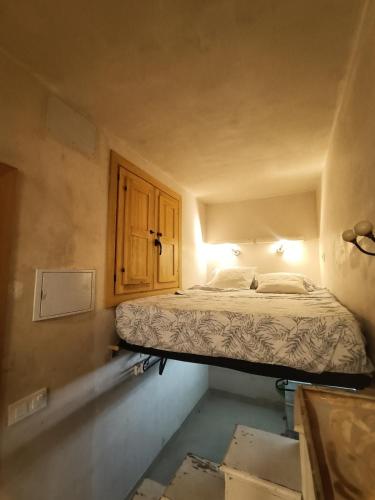 a bedroom with a bed in the corner of a room at Tiny house 4 metro stops from downtown in San Juan de Aznalfarache