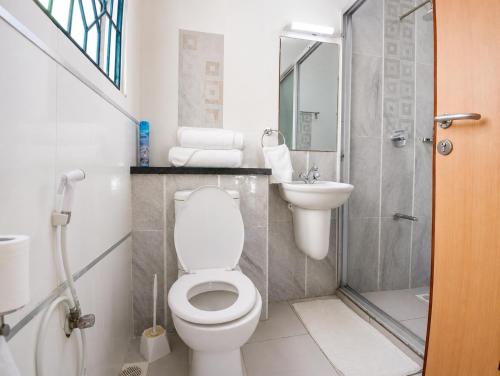 a bathroom with a toilet and a sink and a shower at Ary Homestay Nyali At Pearl Residence 3rd Avenue Nyali, Mombasa, Kenya in Nyali