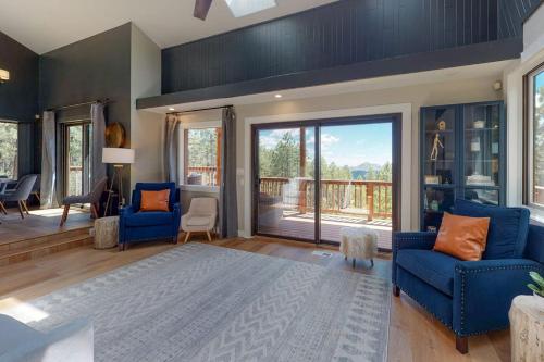 a living room with blue chairs and a large glass door at Mountain View Retreat in Durango