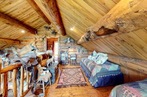 a log cabin room with a bed and a couch at Durango Dreams in Durango