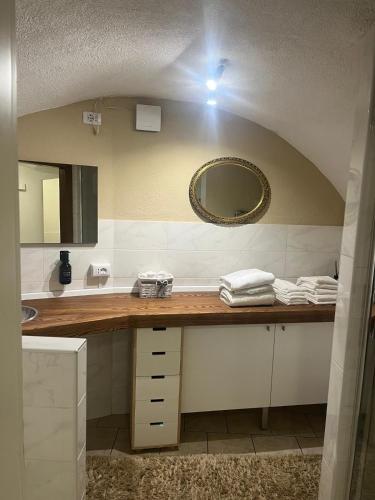a bathroom with a sink and a mirror at Appartamento incantevole Fondo Val di Non in Fondo