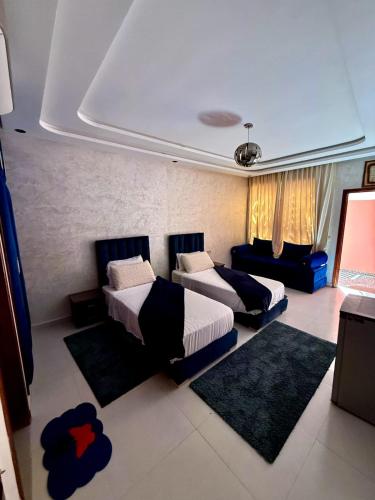 a bedroom with two beds and rugs in it at Riad Dar Salam in Agadir