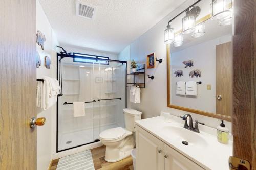 a bathroom with a shower and a toilet and a sink at Yatahey in South Fork