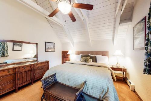 a bedroom with a bed and a dresser and a mirror at Alpine Bliss in Durango