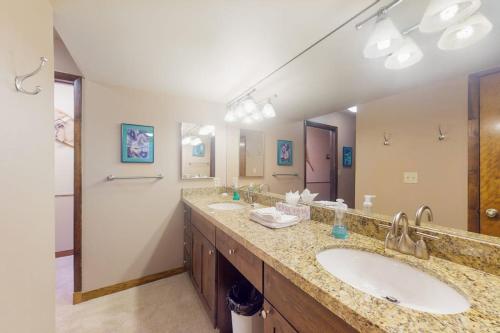a bathroom with two sinks and a large mirror at Basking in Breckenridge Brilliance in Breckenridge