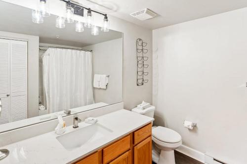 a bathroom with a sink and a toilet and a mirror at First Tracks 4105 in Steamboat Springs