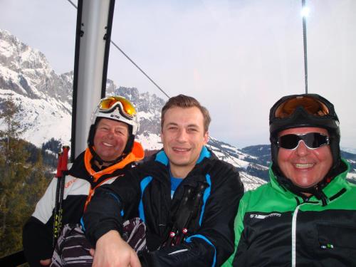 a group of three men on a ski lift at Hotel Gasthof Tirolerwirt in Bischofshofen